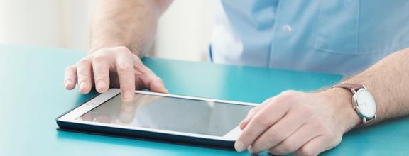 Closeup of man using a tablet